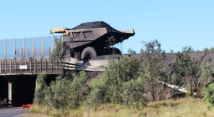 A coal laden dump truck traveling from the mine to the loading facility